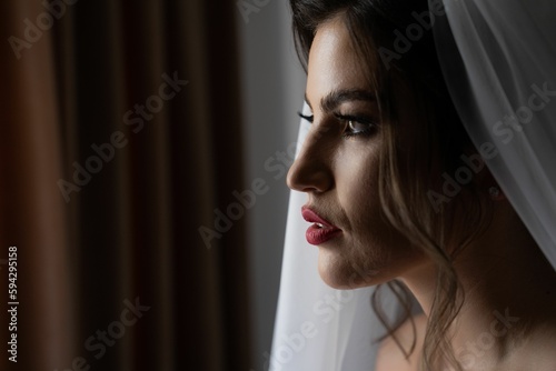 Beautiful young bride posing dramatically in a beautiful veil