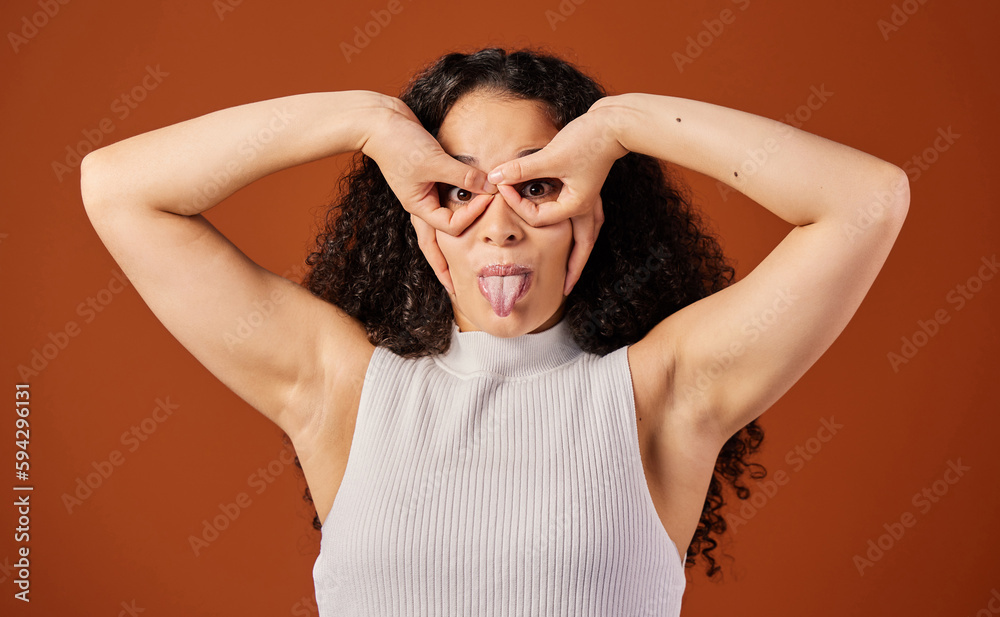 Everyone loves a little quirky. Cropped portrait of an attractive young woman making a face in studio against a red background.