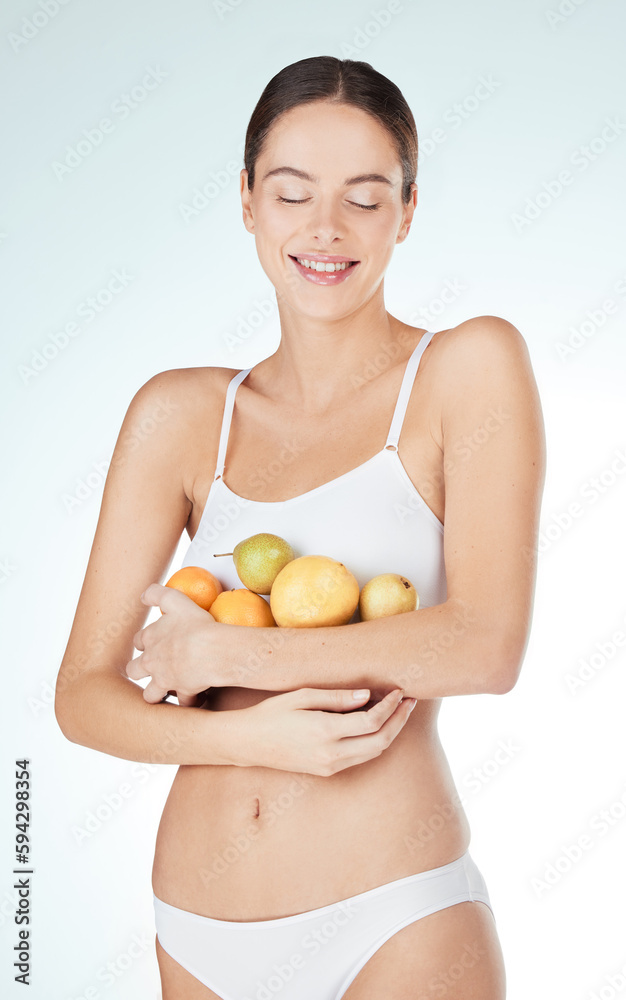 Feed your body, not your emotions. Studio shot of an attractive and fit young woman holding fruit against a blue background. Feed your body, not your emotions. Studio shot of an attractive and fit young woman holding fruit against a blue background.