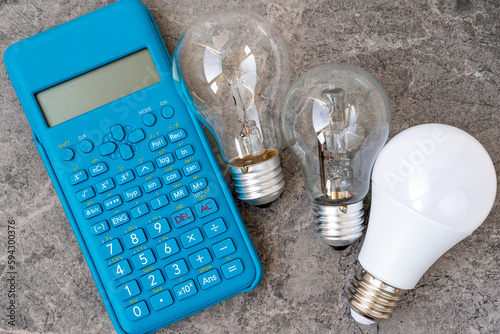 Three different types light bulbs and blue modern calculator