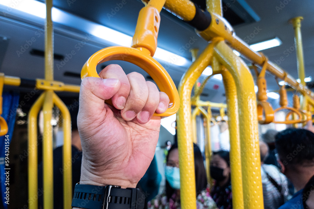 Hands holding handrails of public transport risk germs transmission and infections