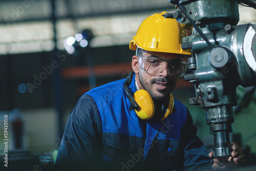 male worker or engineer Inspecting industrial machinery. The concept of a heavy industrial plant.