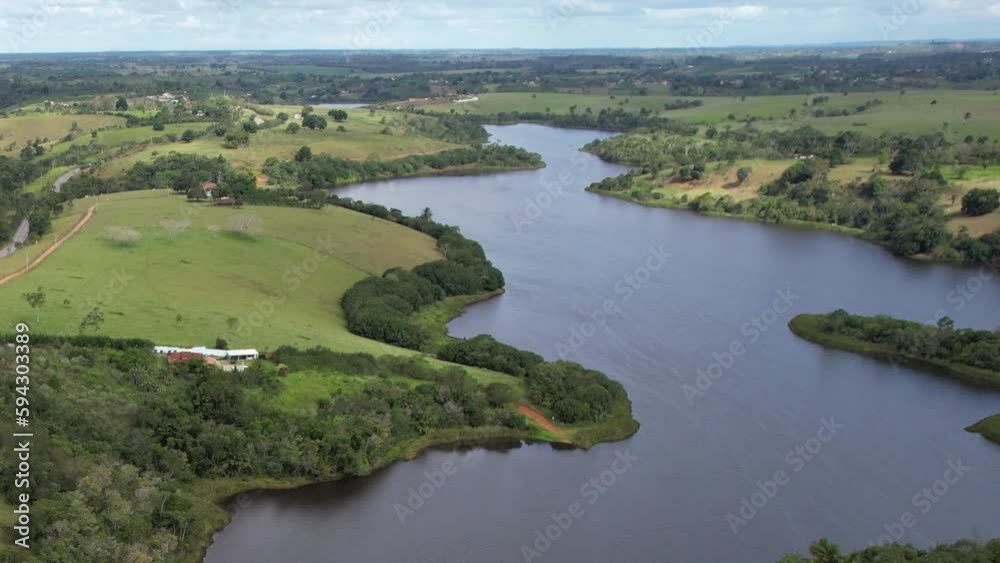 Aerial video of the small town surrounded by trees in the forest and curvy rivers Aerial video of the small town surrounded by trees in the forest and curvy rivers