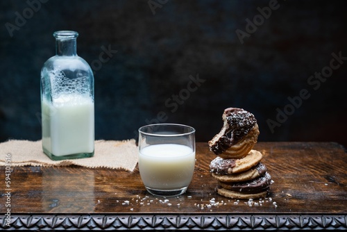 Closeup shot of a glass of milk and cookies on the table