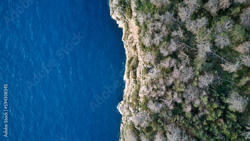 A breathtaking view of the azure sea from atop a cliff in Faralya, Turkey - untouched beauty in nature.