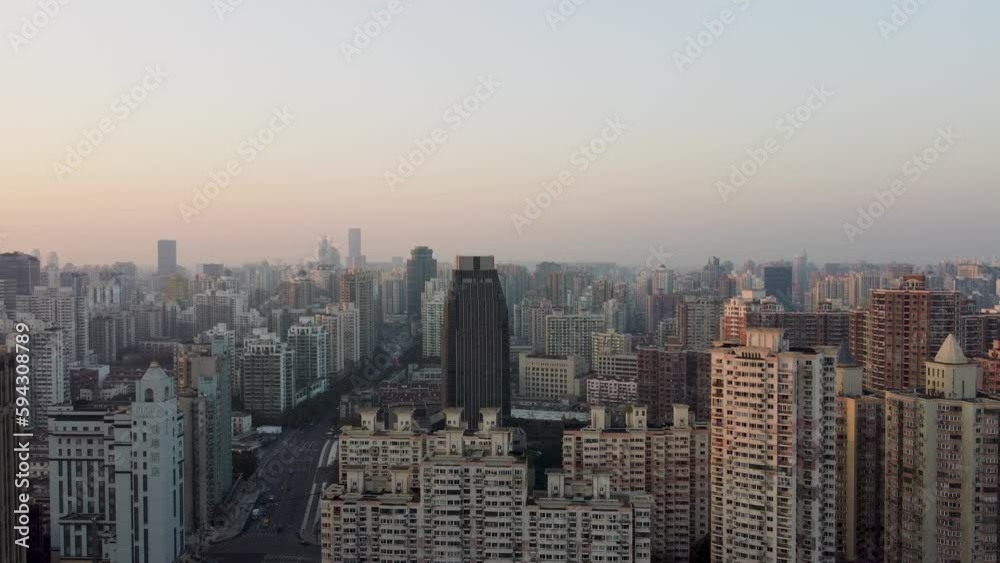 Drone view over a cityscape with high-rise buildings during a sunset Drone view over a cityscape with high-rise buildings during a sunset