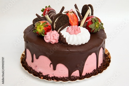 Closeup shot of a strawberry chocolate cake with different sweets on the top