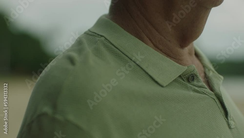 closeup of an old man being tapped on the shoulder by his son's hand
