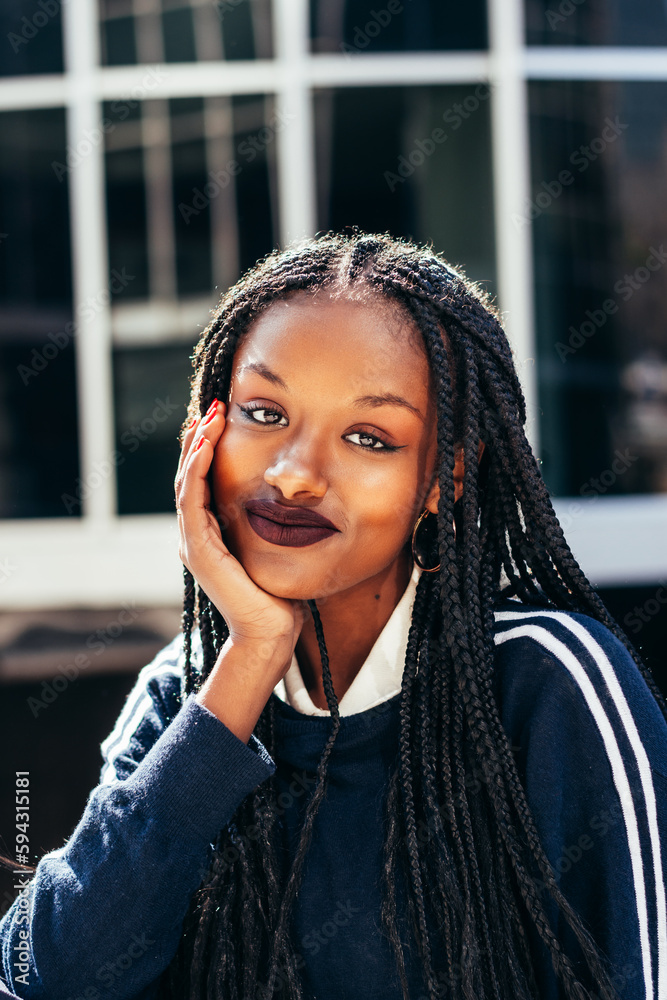 African American woman with Afro braids looking at camera African American woman with Afro braids looking at camera