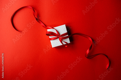 White gift box with red ribbon photo