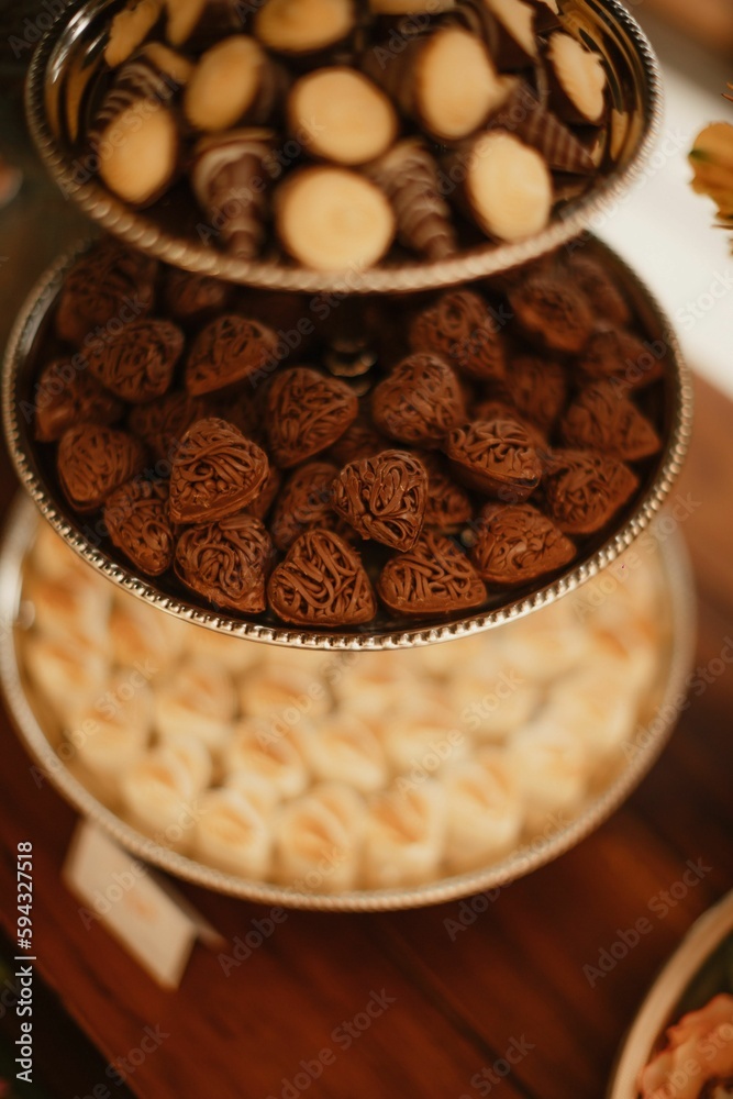 Variety of delicious desserts on trays on a table during a wedding celebration