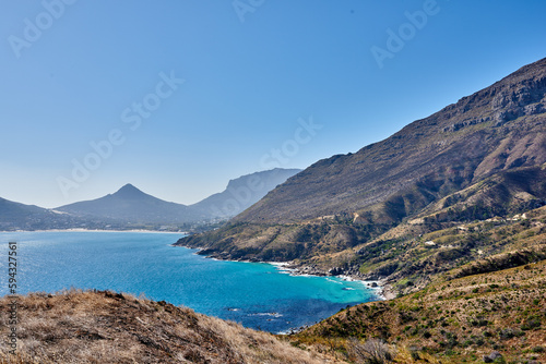 A photo of mountains, coast and ocean from Shapmanns Peak,. A photo mountains, coast and ocean from Shapmanns Peak, with Hout Bay in the background. Close to Cape Town. © SteenoWac/peopleimages.com
