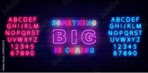 Something big is coming neon emblem. Colorful sign on brick wall. Special offer label. Vector stock illustration
