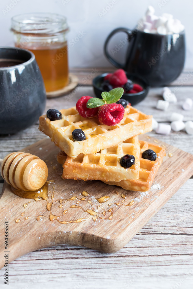 
Belgian waffles with berries. Morning. On a wooden background
