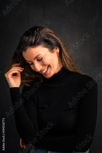 Beautiful brunette haired woman studio portrait against at isolated background