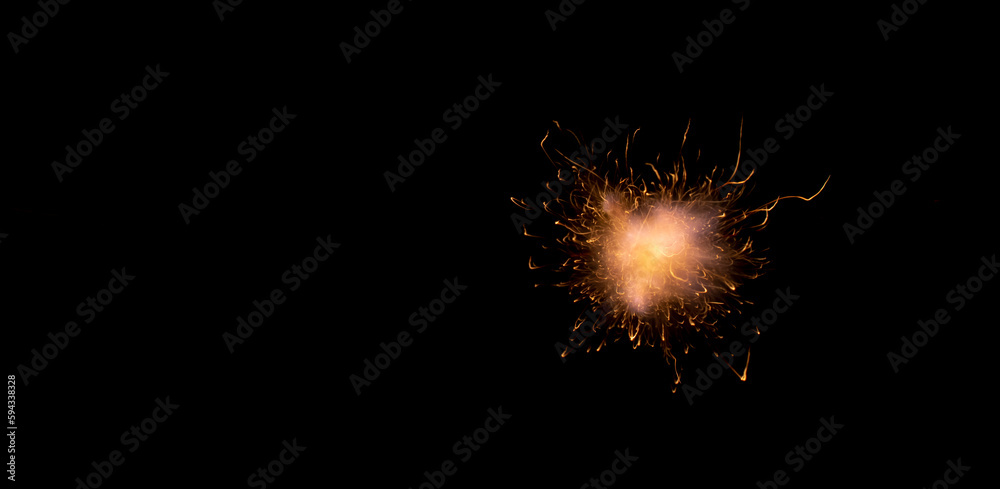 exploding fireball with sparks on black background