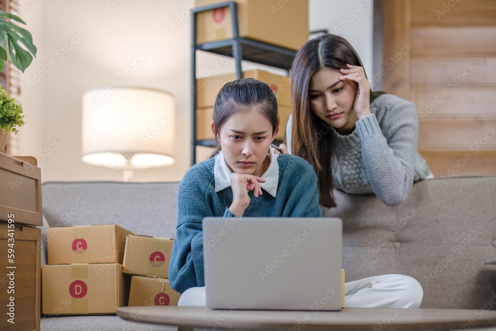 SME e commerce shopping online concept. Attractive serious young woman startup small business entrepreneur using notebook pc on online market summer sale. pregnant lady coworker packing box. SME e commerce shopping online concept. Attractive serious young woman startup small business entrepreneur using notebook pc on online market summer sale. pregnant lady coworker packing box.