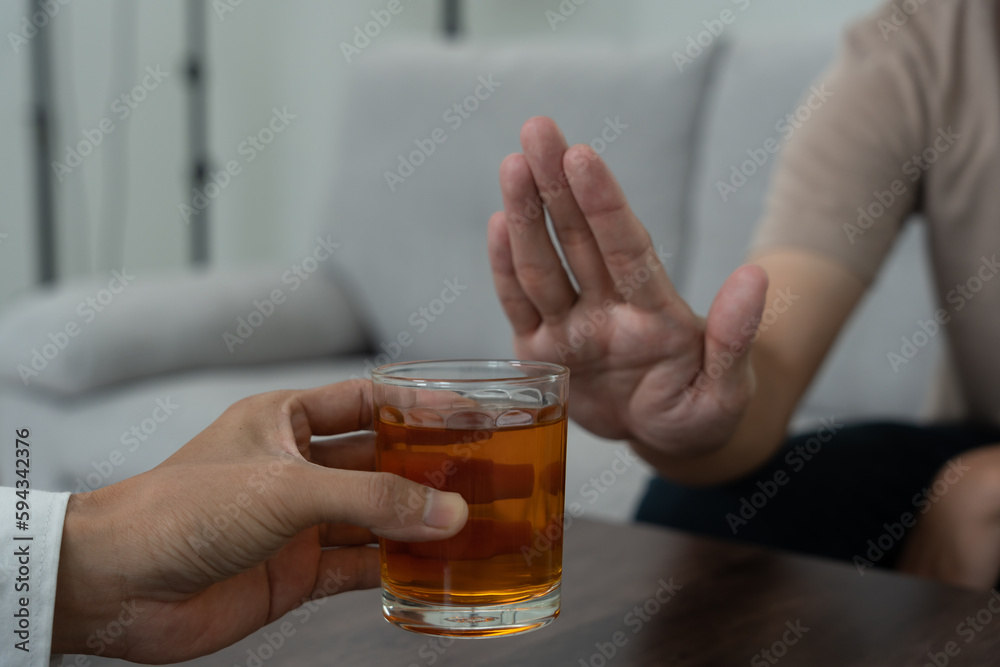 man refuses say no and avoid to drink an alcohol whiskey , stopping hand sign male, alcoholism treatment, alcohol addiction, quit booze, Stop Drinking Alcohol. Refuse Glass liquor, unhealthy, reject. man refuses say no and avoid to drink an alcohol whiskey , stopping hand sign male, alcoholism treatment, alcohol addiction, quit booze, Stop Drinking Alcohol. Refuse Glass liquor, unhealthy, reject.