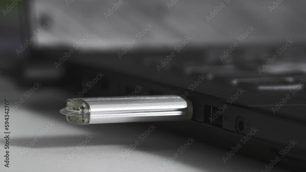 data transfer, flash drive is plugged into USB connector on computer, light is flashing red indicating connection, close-up data transfer, flash drive is plugged into USB connector on computer, light is flashing red indicating connection, close-up