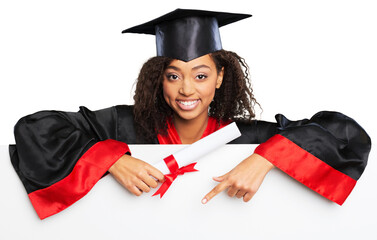 Smiling female graduate holding a sign with diploma.
