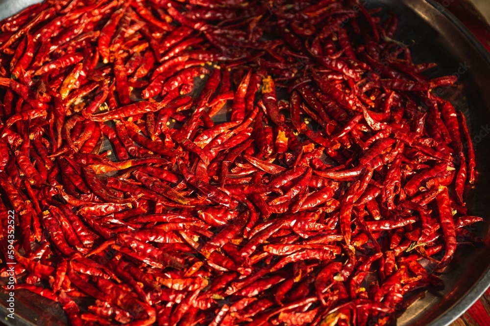 Fototapeta premium Closeup shot of a pan filled with dried red chili peppers