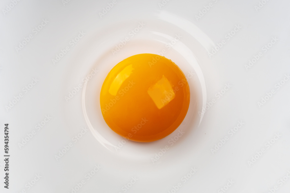 Egg yolk on the plate. Abstract fried eggs. Close up. Egg yolk on the plate. Abstract fried eggs. Close up.