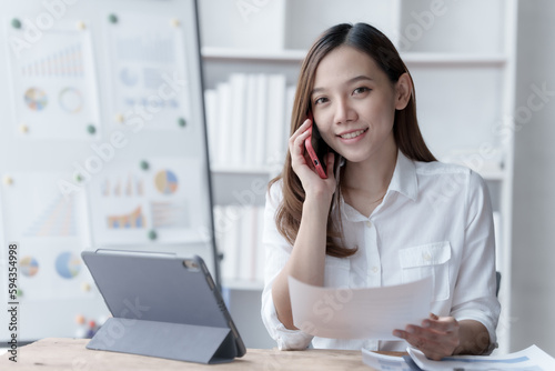 Confident Asian businesswoman calculating finances in the accounting and balance sheet work of the stock market and international exchange rates, Authorized Share Capital, Owners Equity, Common Stock