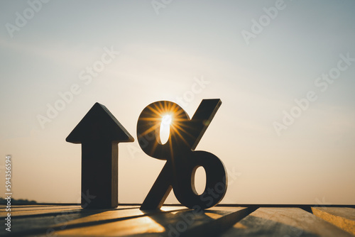 Silhouette of percentage model and up arrow with evening sky Key concepts for success, methods, systems of raising or lowering Fed interest rates to correct inflation concepts.