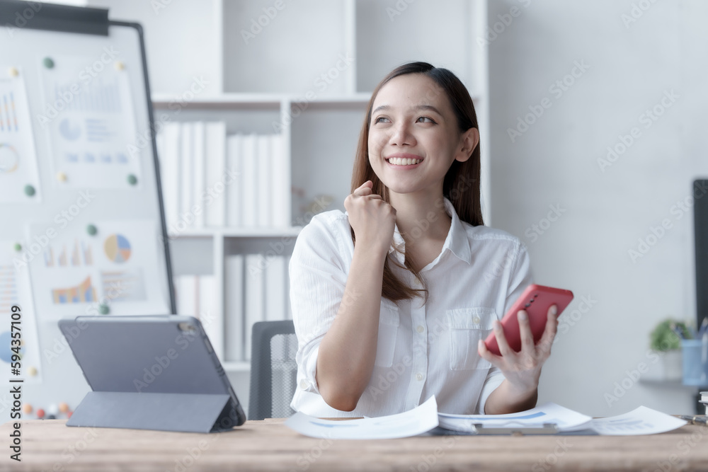 Confident Asian businesswoman calculating finances in the accounting and balance sheet work of the stock market and international exchange rates, Authorized Share Capital, Owners Equity, Common Stock Confident Asian businesswoman calculating finances in the accounting and balance sheet work of the stock market and international exchange rates, Authorized Share Capital, Owners Equity, Common Stock