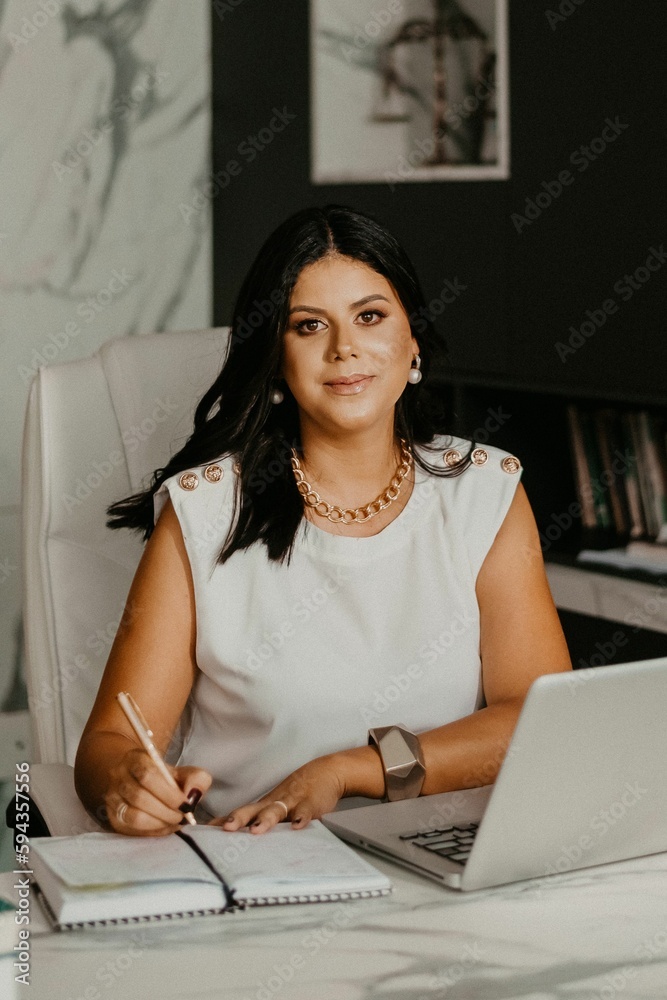 Female professional at her home office, smiling with contentment Female professional at her home office, smiling with contentment