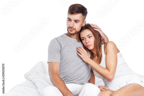 Man consoles his wife lying bed in bedroom, couple consoling, husband embrace comforts his woman