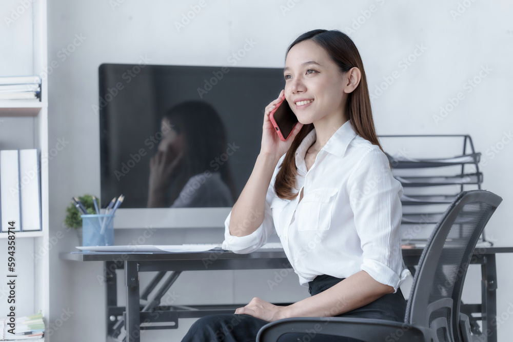 Confident Asian businesswoman calculating finances in the accounting and balance sheet work of the stock market and international exchange rates, Authorized Share Capital, Owners Equity, Common Stock Confident Asian businesswoman calculating finances in the accounting and balance sheet work of the stock market and international exchange rates, Authorized Share Capital, Owners Equity, Common Stock