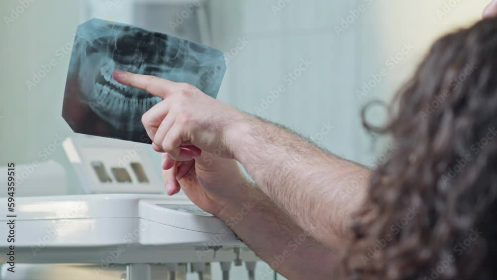 Doctor giving consultation to patient. Dentist discusses with patient situation of her teeth. Dental care concept. Close-up in 4K, UHD Doctor giving consultation to patient. Dentist discusses with patient situation of her teeth. Dental care concept. Close-up in 4K, UHD