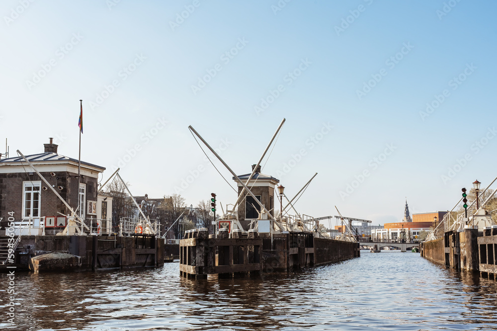 Historic water locks on the Amstel river in Amsterdam, regulation of the water level in the river and canals. Historic water locks on the Amstel river in Amsterdam, regulation of the water level in the river and canals.
