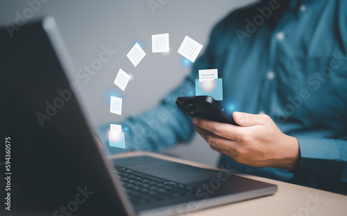 Businessman use phone for send document on internet or network to computer. Data transfer file between device, Backup data, Exchange file on folder, DMS. Virtual document loading to another folder.