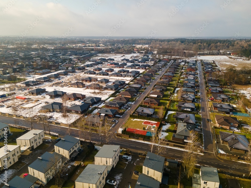 Aerial view o a suburban area covered in the snow under the sunlight