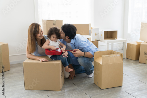 Moving house, mortgage, family and real estate concept. Happy family with little daughter baby toddler girl moving into new house