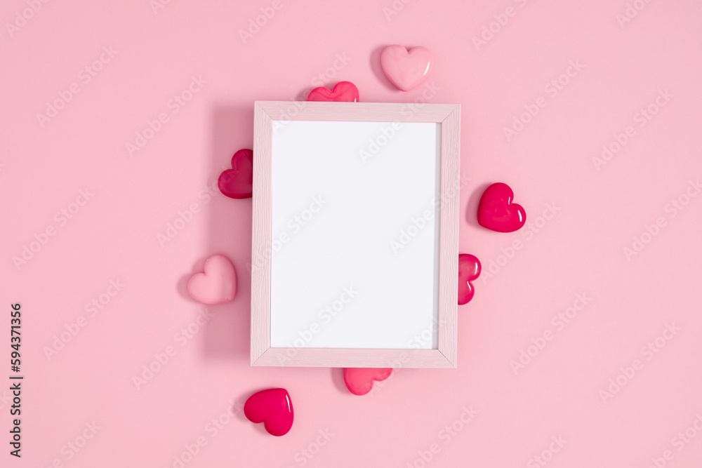 Valentine's day concept. Photo frame, pink hearts on pastel pink background. Love concept. Saint Valentine. Flat lay, top view, copy space