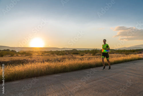 Triathlete in professional gear running early in the morning, preparing for a marathon, dedication to sport and readiness to take on the challenges of a marathon. 