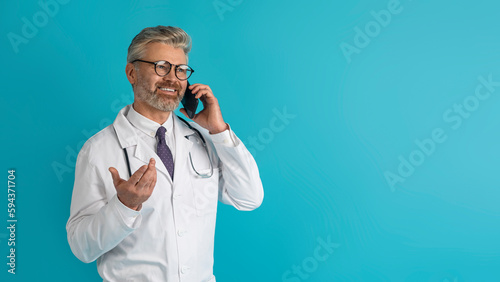 Happy grey-haired doctor have phone call with patient, copy space