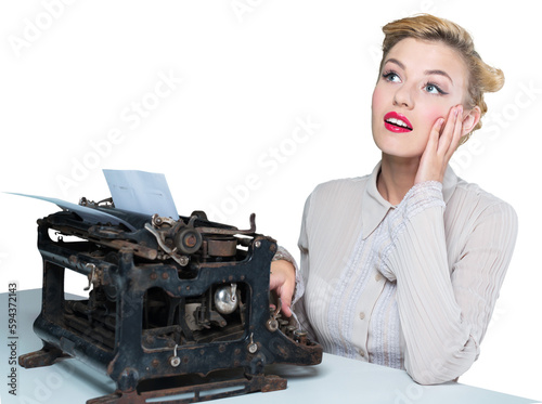 Retro woman working in office with vintage typewriter and phone, dressed in pin-up style photo