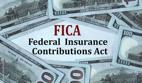 FICA - acronym on the background of cash dollar bills photo