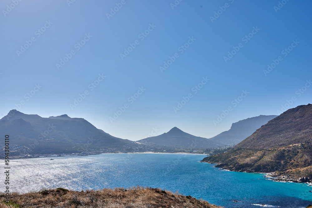 A photo of mountains, coast and ocean from Shapmanns Peak,. A photo mountains, coast and ocean from Shapmanns Peak, with Hout Bay in the background. Close to Cape Town. A photo of mountains, coast and ocean from Shapmanns Peak,. A photo mountains, coast and ocean from Shapmanns Peak, with Hout Bay in the background. Close to Cape Town.