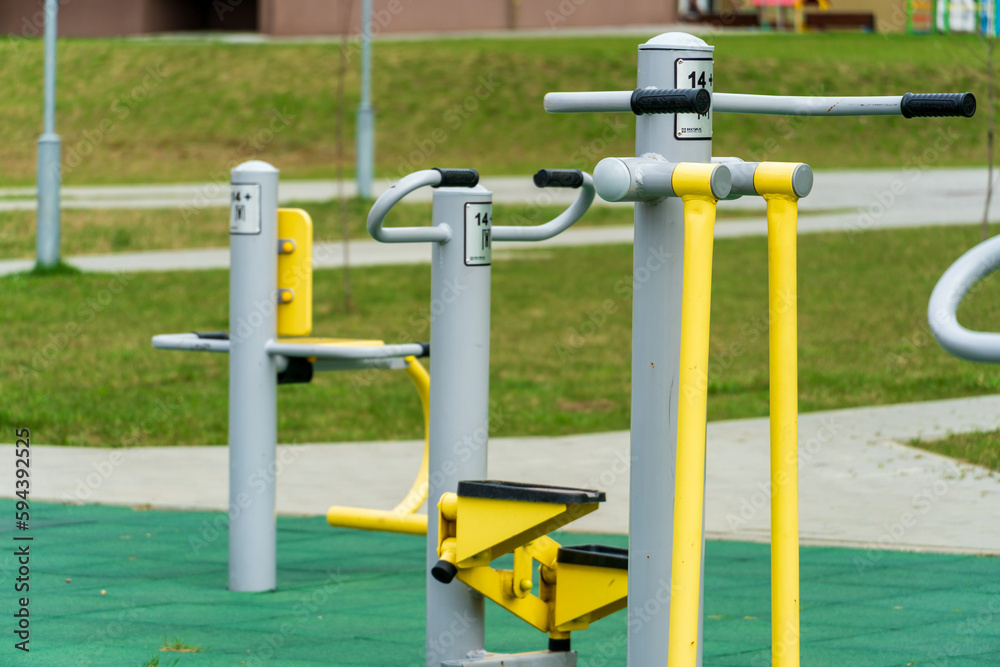 An empty outdoor sports ground with outdoor exercise equipment and modern rubber coating. Metal vandal-proof sports equipment in the park. Outdoor sports and fitness activities. An empty outdoor sports ground with outdoor exercise equipment and modern rubber coating. Metal vandal-proof sports equipment in the park. Outdoor sports and fitness activities.