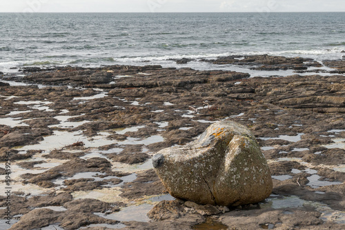 Big rock formed as cartoon dog snoopy on easky county Sligo beach Ireland photo