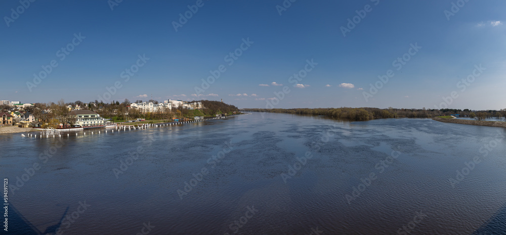 Landscape with river, forest and embankment in the city in spring.  Flood and flood of river water in spring. Rivers of Belarus. the city of Gomel. Europe.