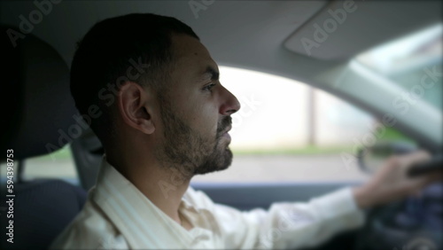 Profile closeup face of one Arab man driving car. Interior shot of a Concentrated Middle Eastern male person drives vehicle