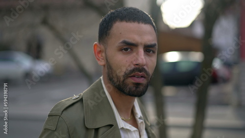 Obraz na plátne Portrait face of a Middle Eastern young man with serious expression staring at c