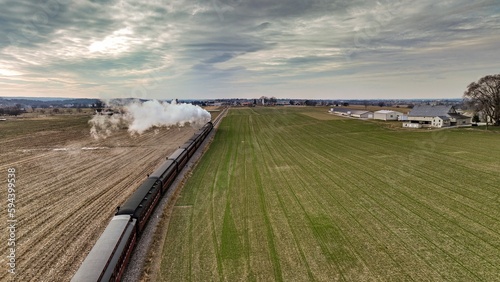 Принти на полотні Vintage locomotive train chugging along railroad tracks in a scenic countryside