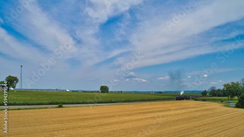 Принти на полотні Vintage locomotive train chugging along railroad tracks in a scenic countryside